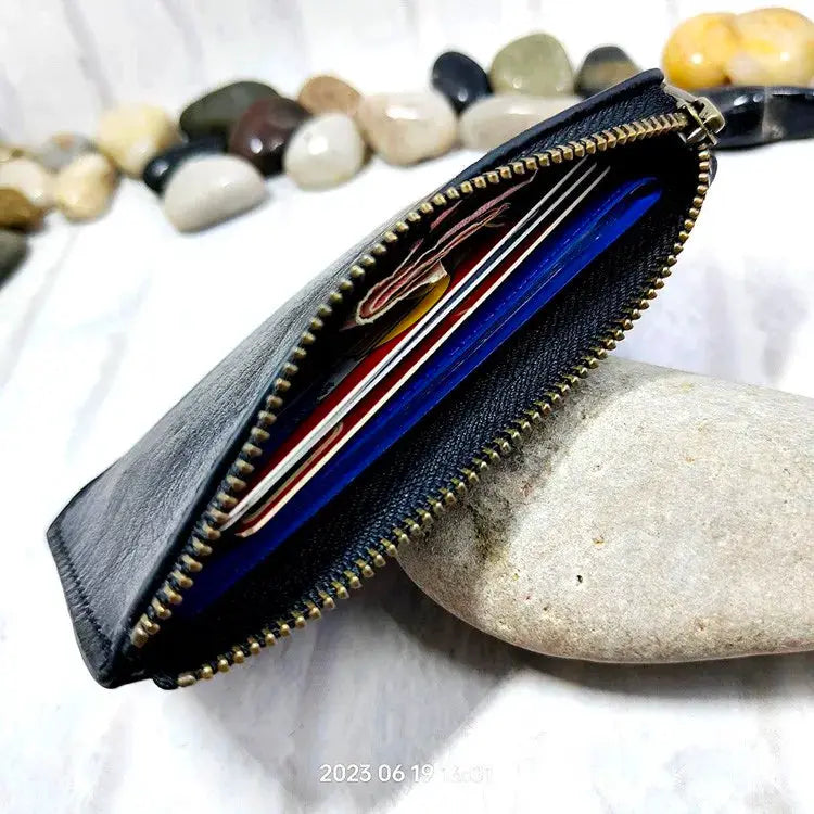 Black leather mini zipper wallet with card slots and zipper closure
