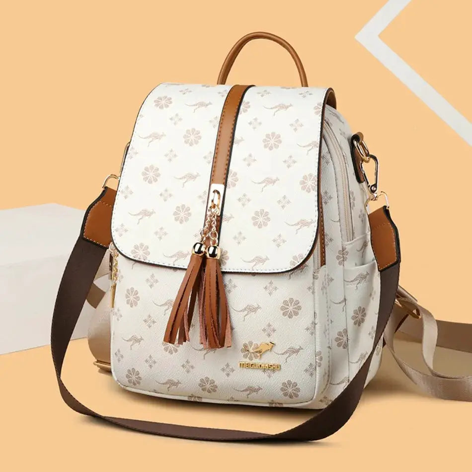 Simples Market ladies leather backpack in cream with brown straps, tassel charms, floral print, large-capacity.