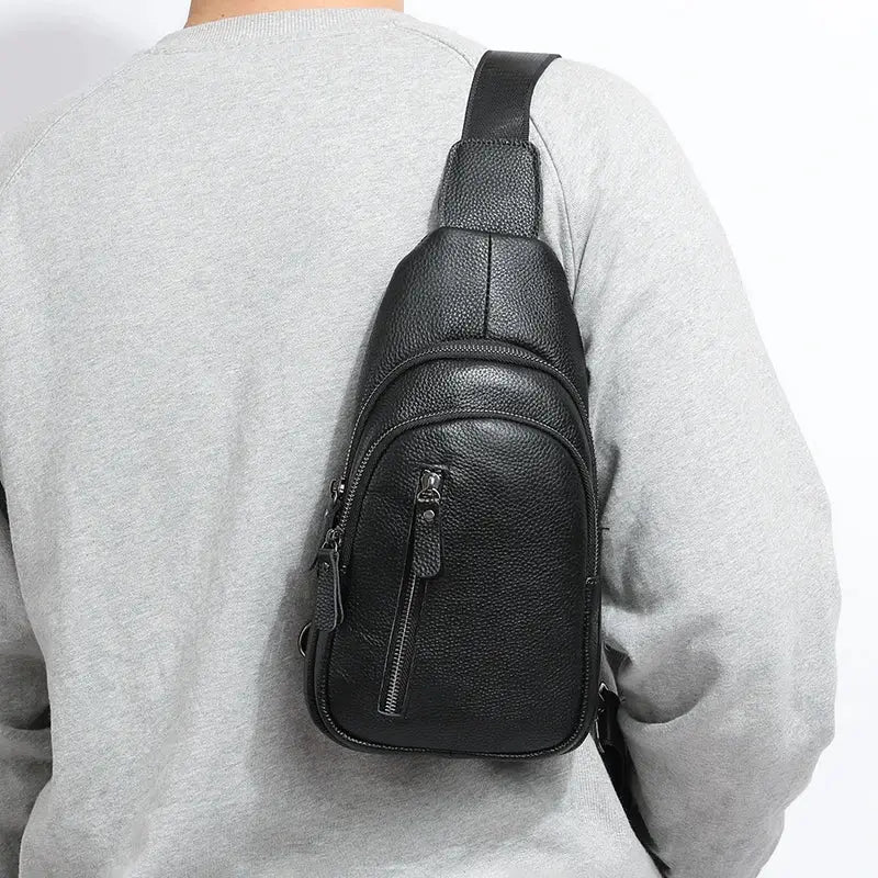Black pebbled leather chest bag with crossbody strap and front zip pocket