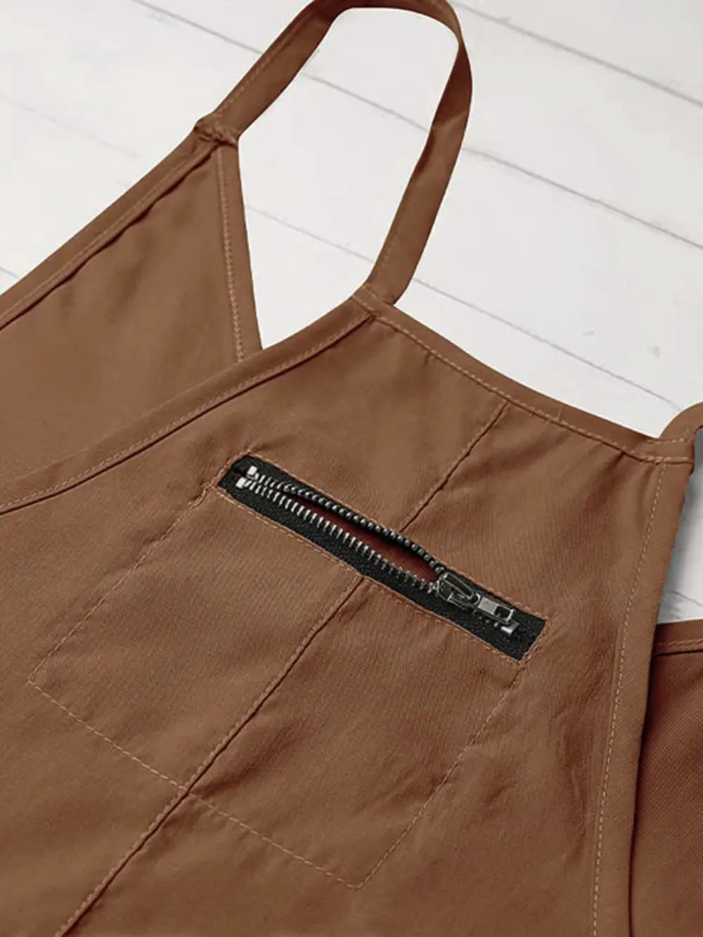 Brown women's suspender jumpsuit with front zipper pocket and thin straps