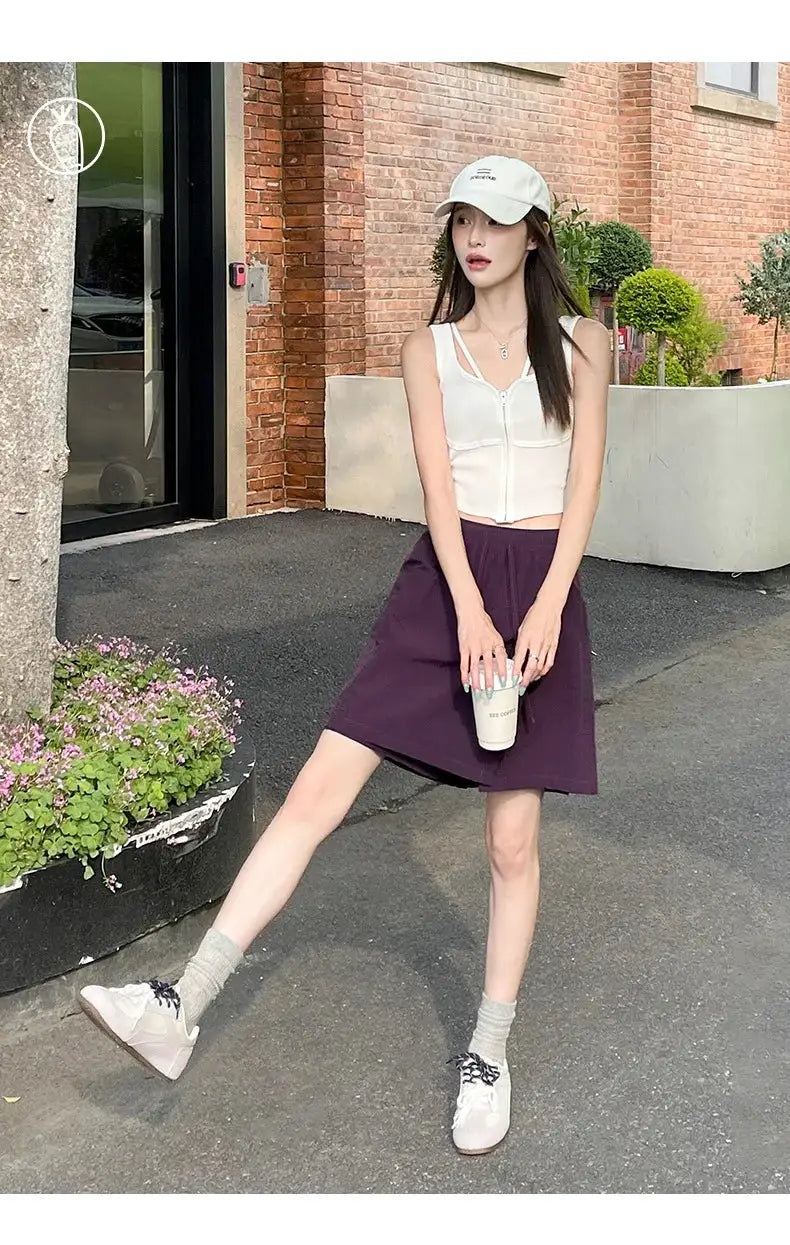 Two-piece women's shorts-skirt set: white sleeveless top paired with a purple high-waist mini skirt, lightweight casual summer style