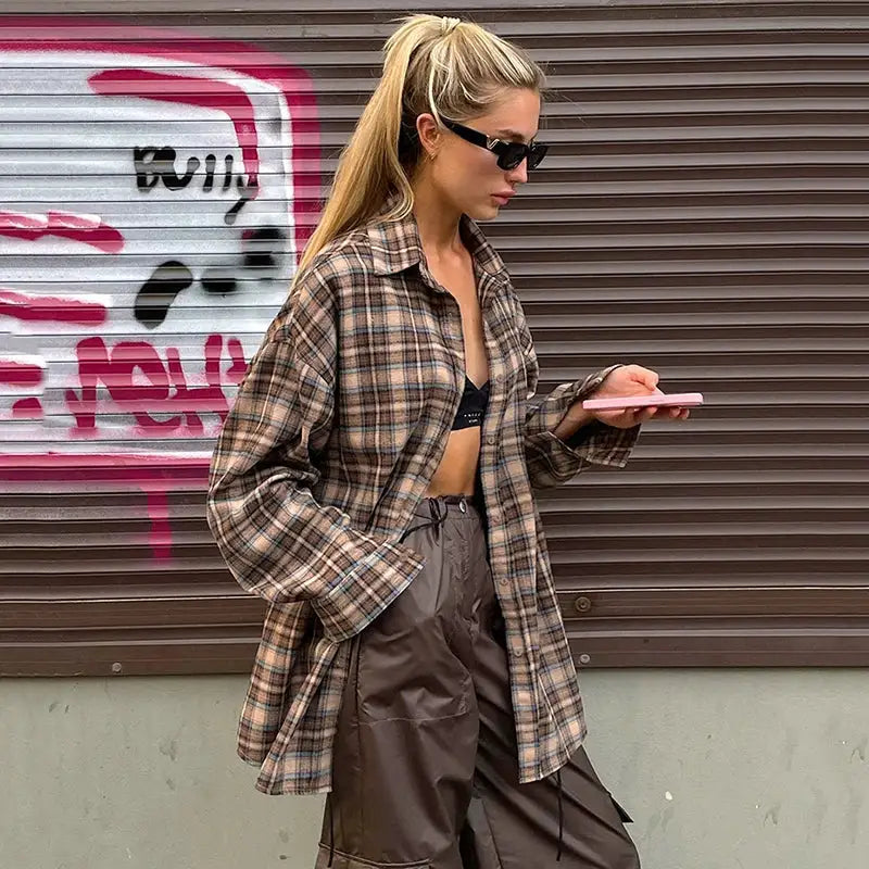 Simples Market plaid checkered shirt worn open over a black bralette with brown cargo pants