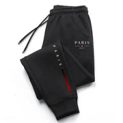 Men's black Paris-printed sweatpants with elastic drawstring waist, cuffed ankles, Paris logo on leg.