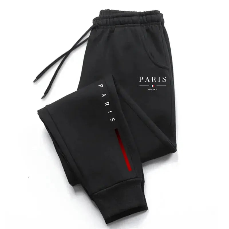 Men's black Paris-printed sweatpants with elastic drawstring waist, cuffed ankles, Paris logo on leg.