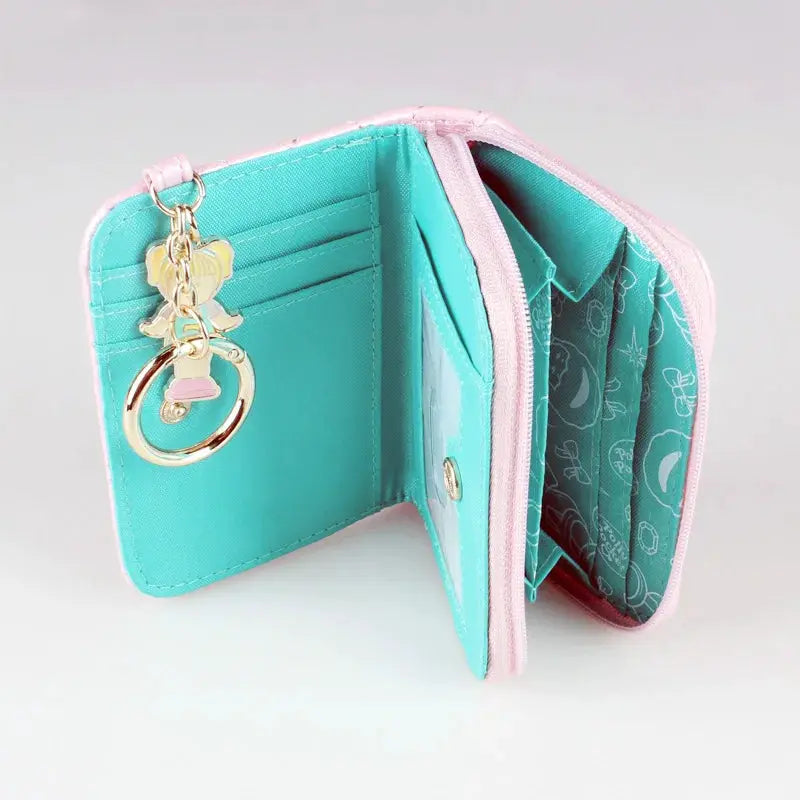 Pink stitched zipper wallet with teal interior, ID card slots, and butterfly charm key ring