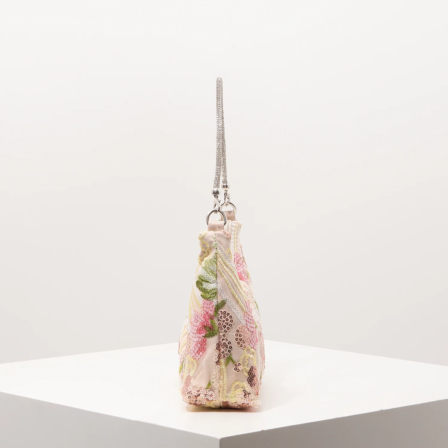 Shoulder bag with pastel pink floral embroidery and sequin accents, silver chain strap