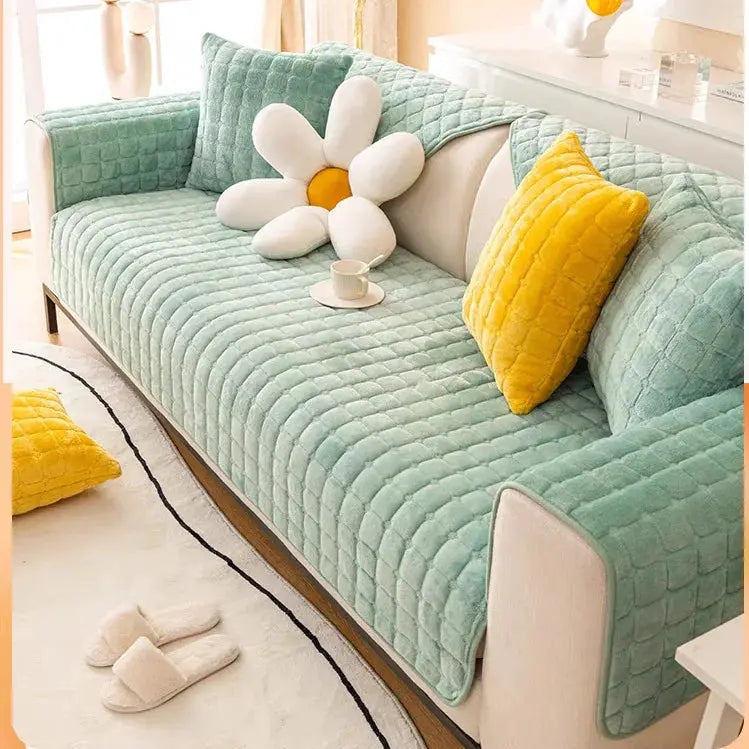 Turquoise quilted flannel sofa cushion cover set on a modern living room sofa with yellow decorative cushions