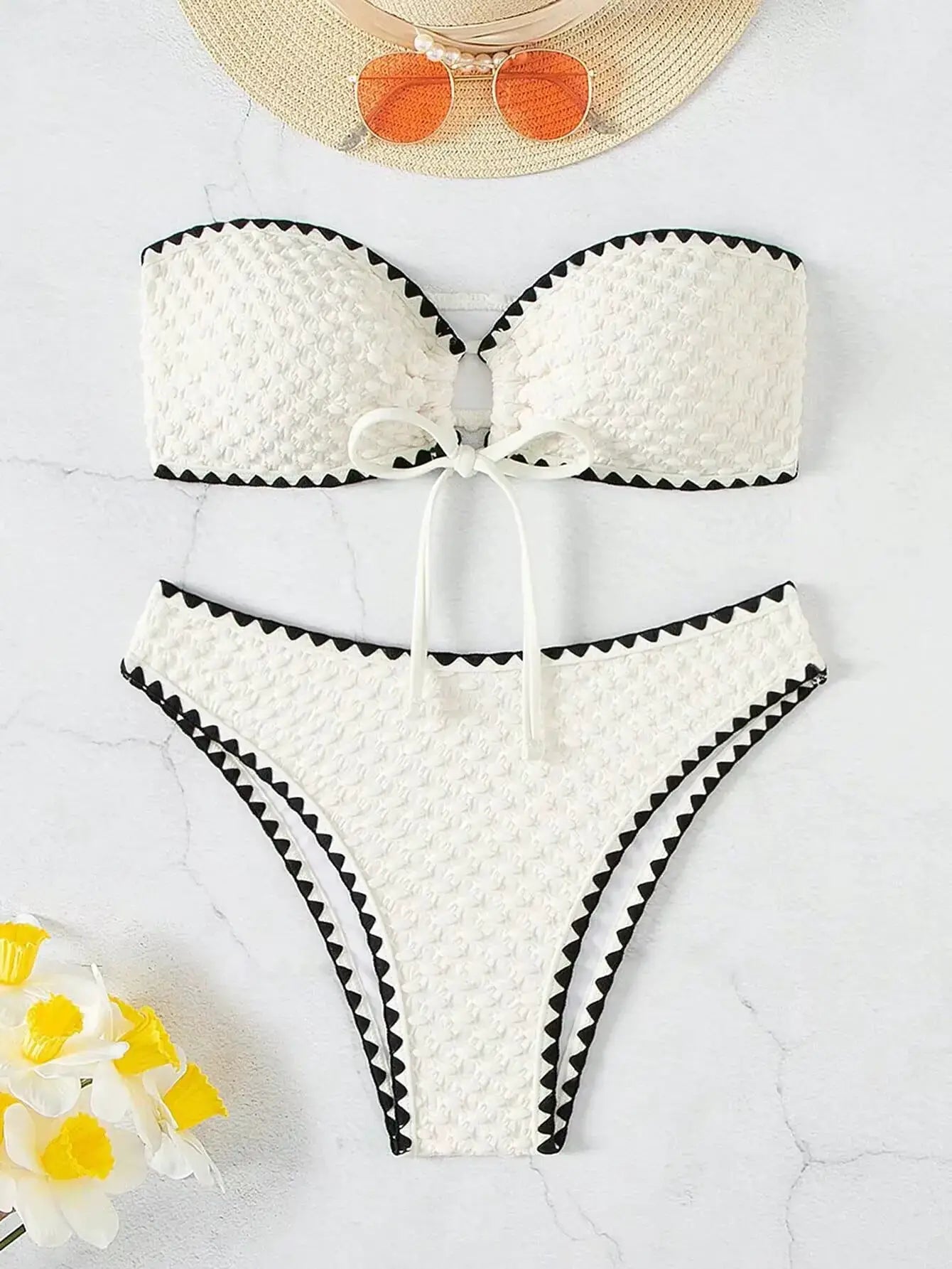 Simples Market white strapless bikini set with textured fabric, black zigzag trim and bow, bandeau top and bottoms