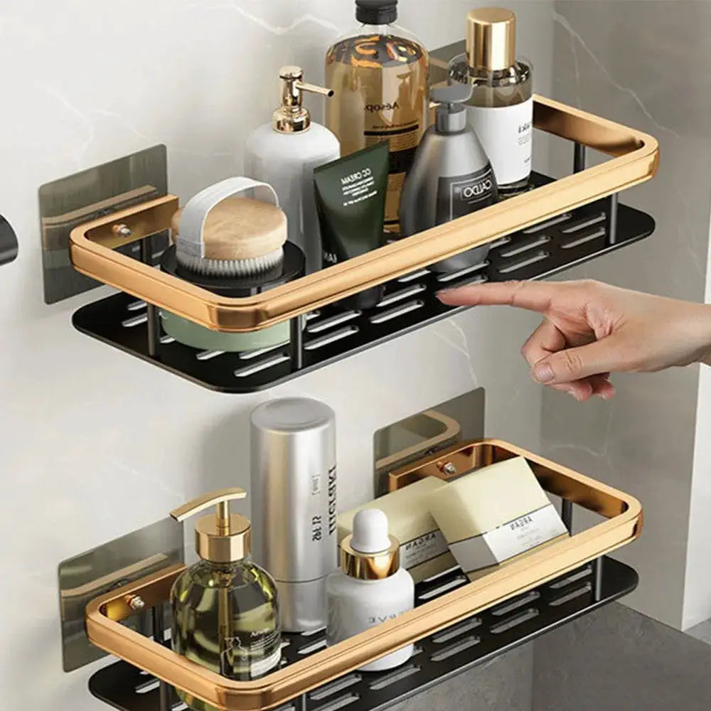 Two gold-tone aluminum wall-mounted bathroom shelves with black trays