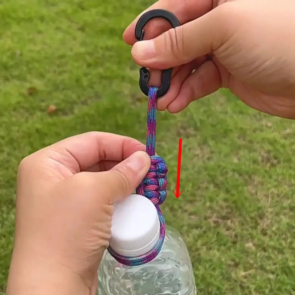 Outdoor water bottle buckle with colorful braided paracord lanyard and black metal ring.