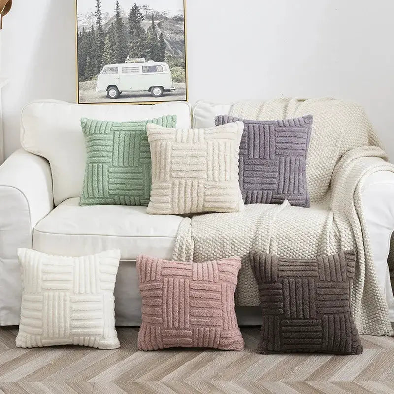 Six Boho faux fur plush pillow covers in cream, mint, ivory, pink, lavender and taupe on a white sofa with a throw.