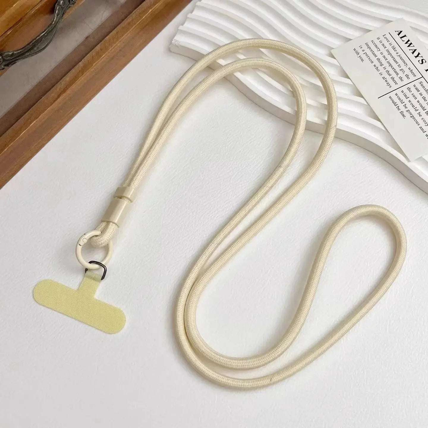 Cream phone lanyard with long rope crossbody strap and metal ring clasp