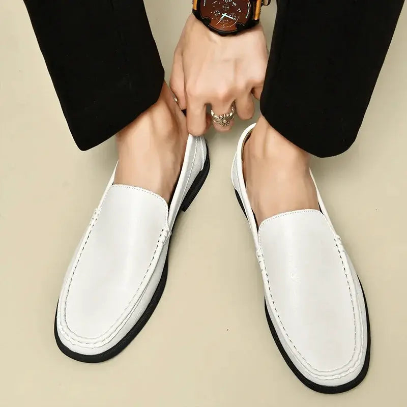 Pair of leather men's white slip-on loafers with black sole