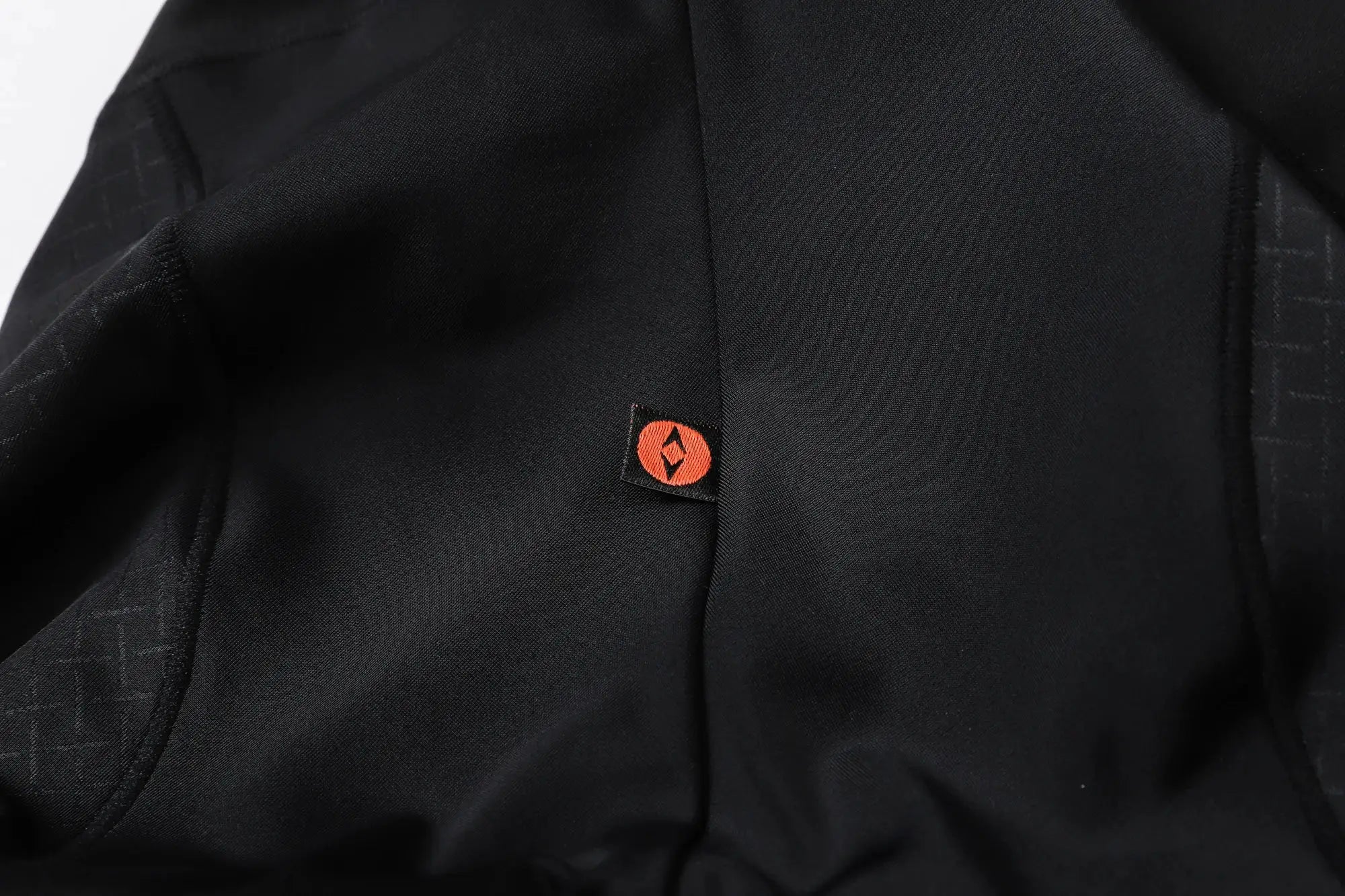 Black men's cycling bib shorts by Simples Market, YKYWBIKE, with orange logo tag.