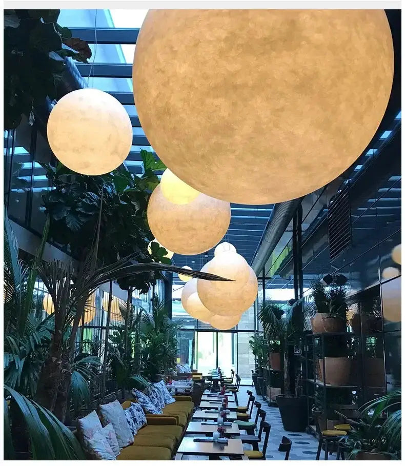Nordic Moon LED pendant lights; large warm-white spherical globes hanging over a cafe dining area.