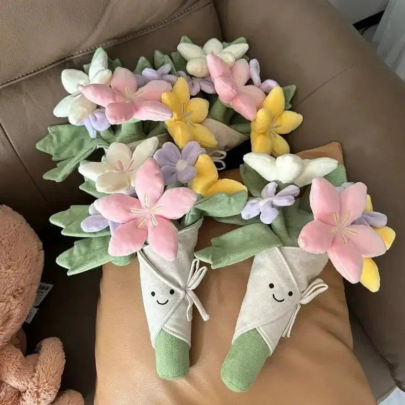 Two plush bouquet stems by Simples Market; pastel fabric flowers in pink, yellow, lavender and white with green stems.