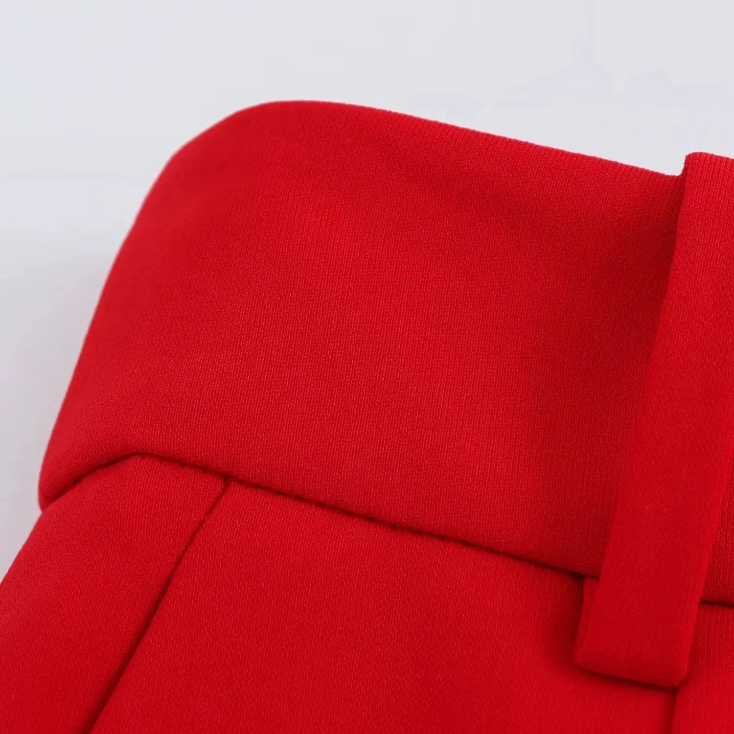KONDALA red sleeveless blazer with sash belt, close-up of textured fabric