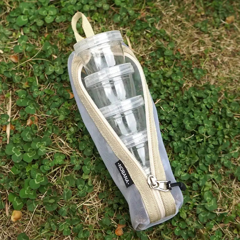 Portable camping spice kit with clear stackable bottles in a gray zippered pouch