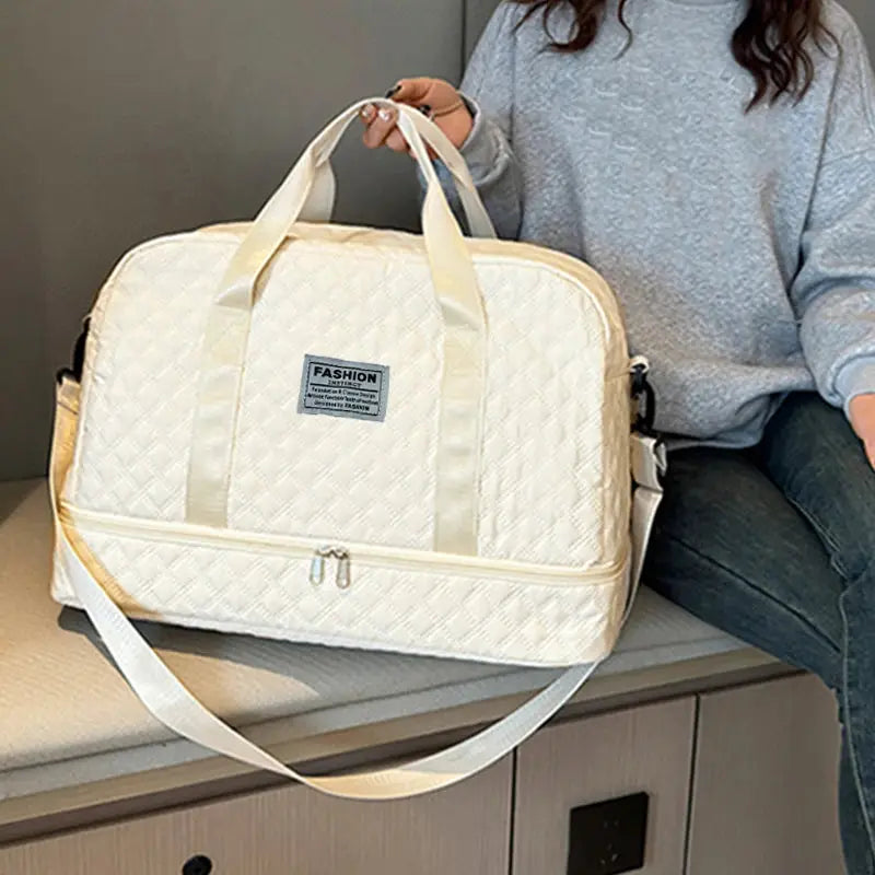 Simples Market quilted cream duffle bag with handles and detachable strap, featuring a fashion emblem on the front