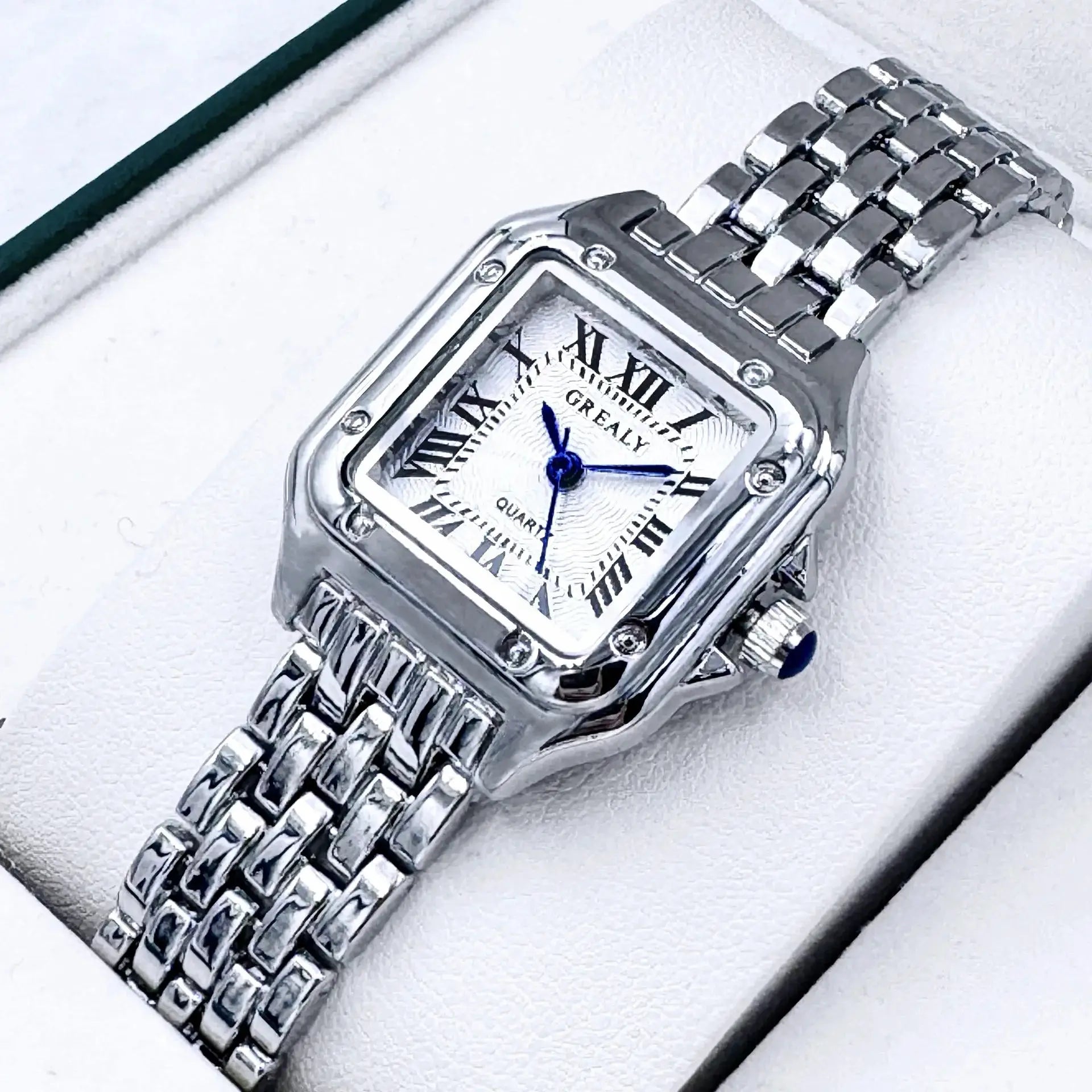 Women's silver stainless-steel wristwatch with rectangular dial, blue hands, quartz movement, and linked bracelet