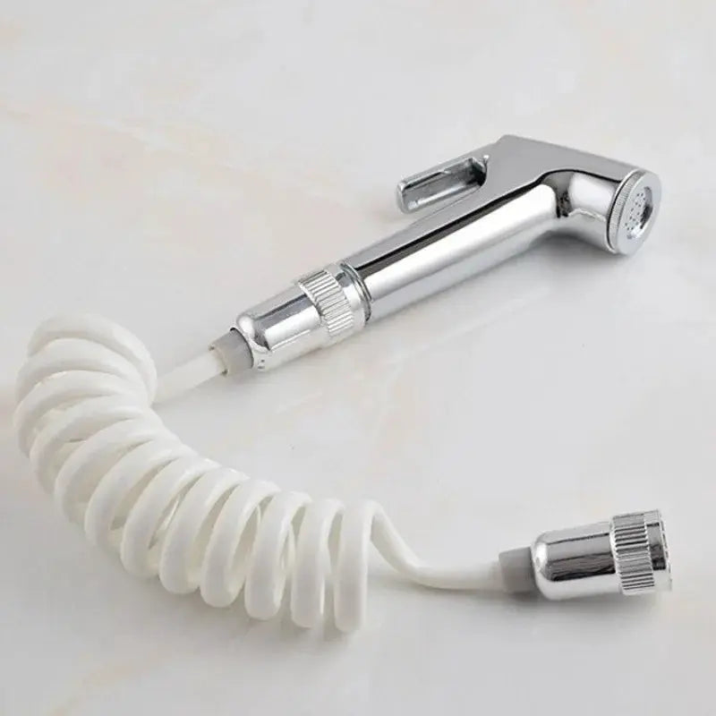 Handheld bidet sprayer with chrome body and white coiled hose by Simples Market