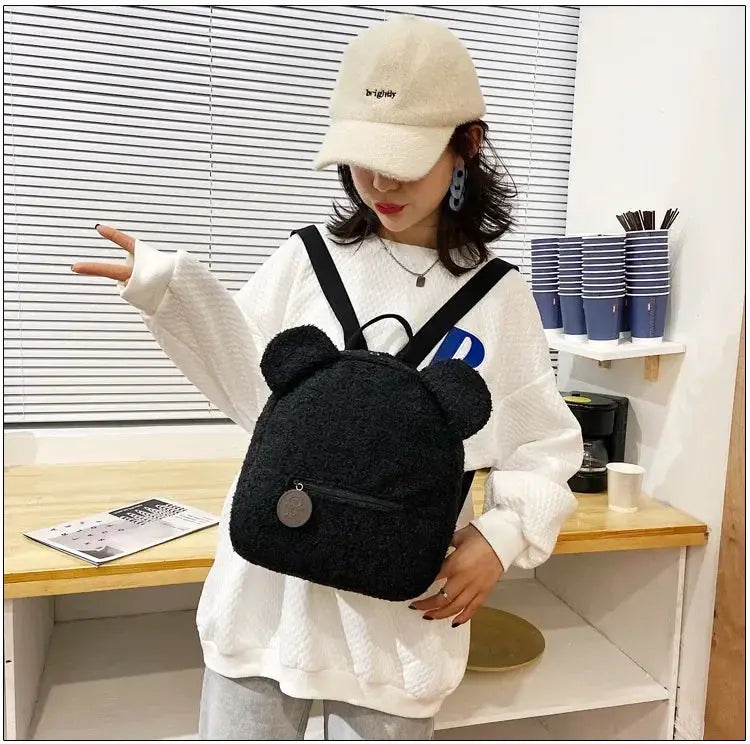 Bear-ear fleece backpack for kids by Simples Market; small black plush daypack with zip pocket.