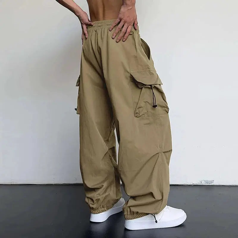 Men's cargo pants by Simples Market in khaki with oversized side pockets, drawstring waist, wide-leg fit.