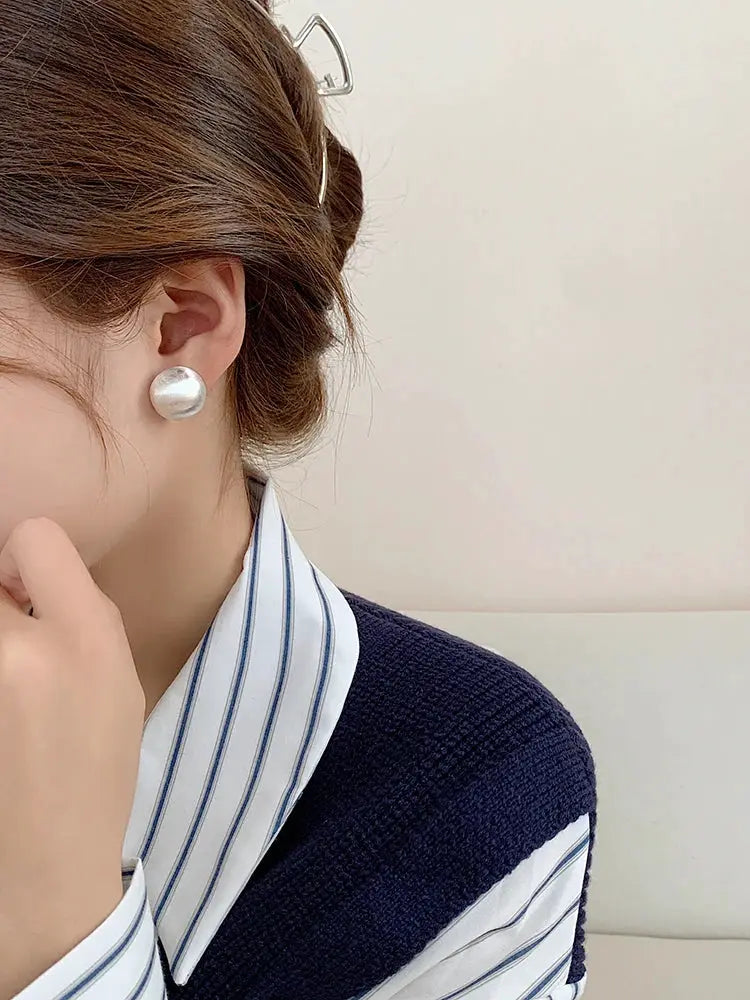 Stud earrings, brushed frosted metal with a simple design; silver tone fashion accessory