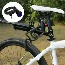 Heavy duty motorcycle chain lock with 2 keys; black metal chain securing a white bicycle frame.
