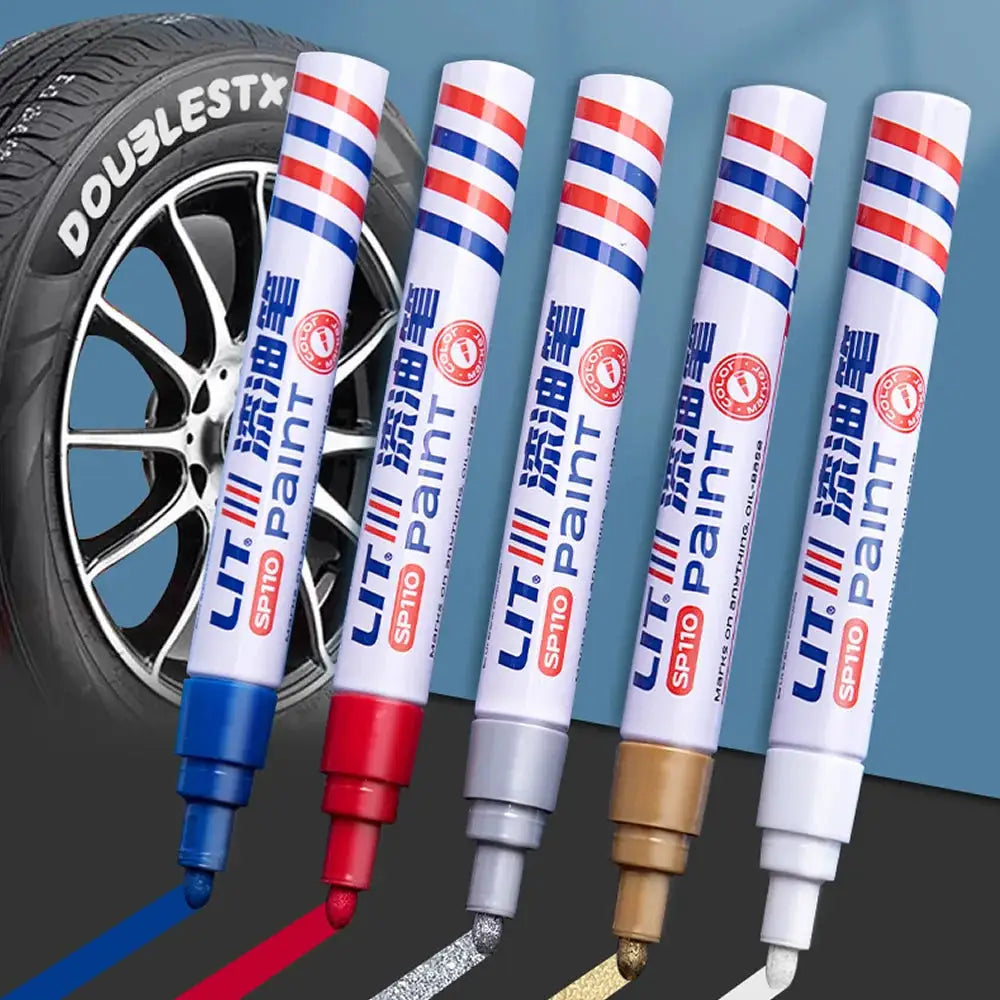 Paint marker set: five color permanent markers with blue, red, gray, gold and white caps, displayed in front of a tire