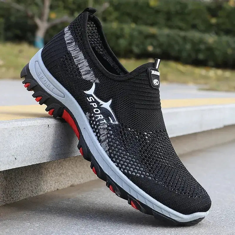 Men's black mesh sneakers with breathable knit upper, white midsole and red outsole accents