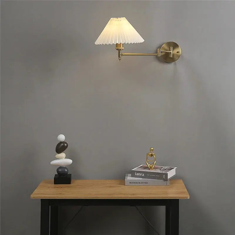 Nordic adjustable folding wall lamp with rotating rocker arm by Simples Market, brass finish, cream pleated shade