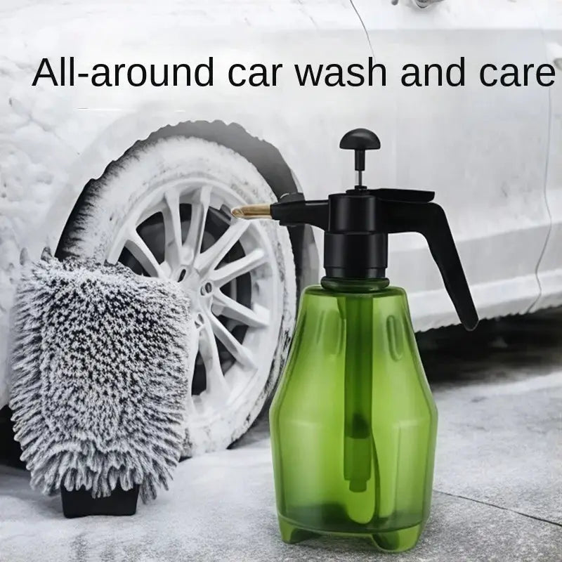 Green 1.5L hand-held car wash spray bottle with black trigger nozzle beside a foam car wash brush