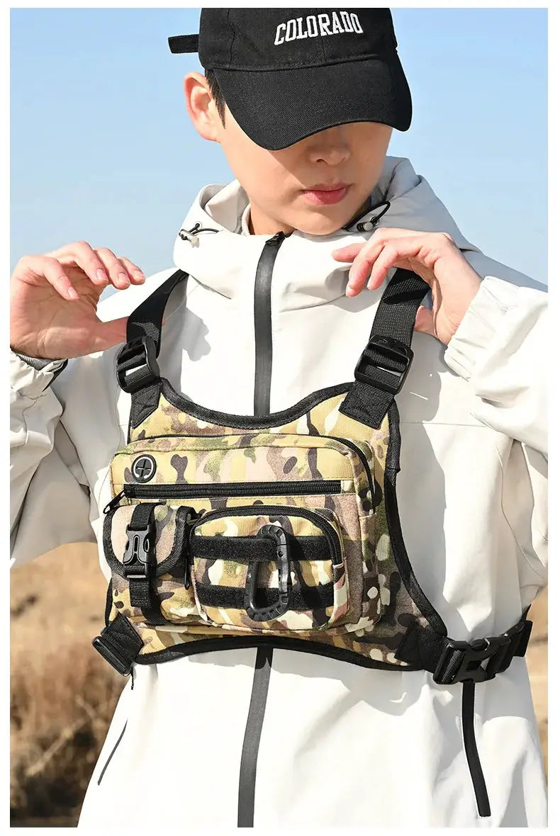 Simples Market outdoor tactical chest bag in woodland camouflage with multiple pockets and adjustable black straps.
