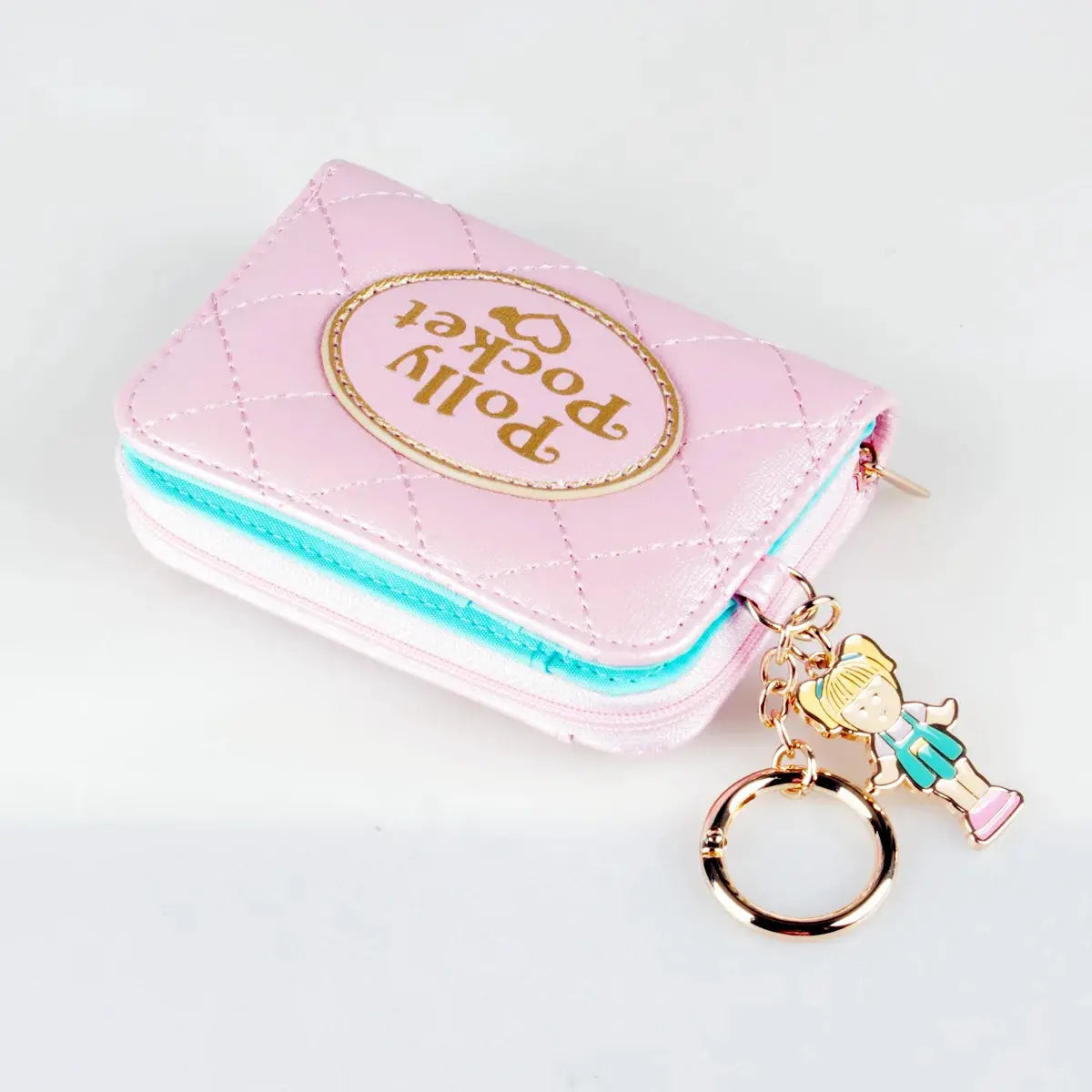 Pink quilted zipper wallet with turquoise edge and Polly Pocket logo, plus a small girl charm on a gold key ring.