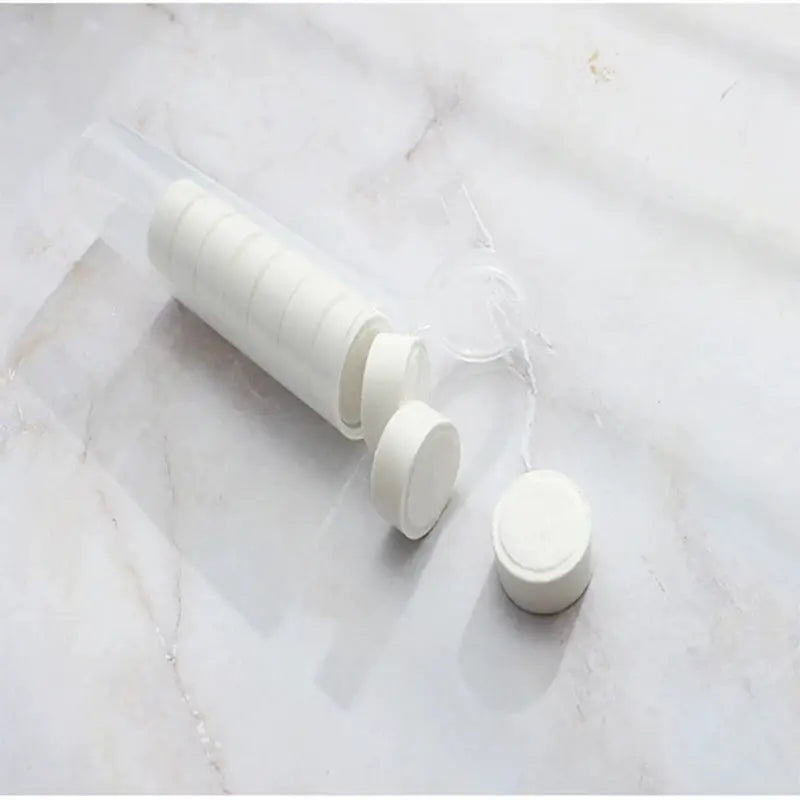 Compressed towels in a clear tube; white round moistened towels for travel, camping.