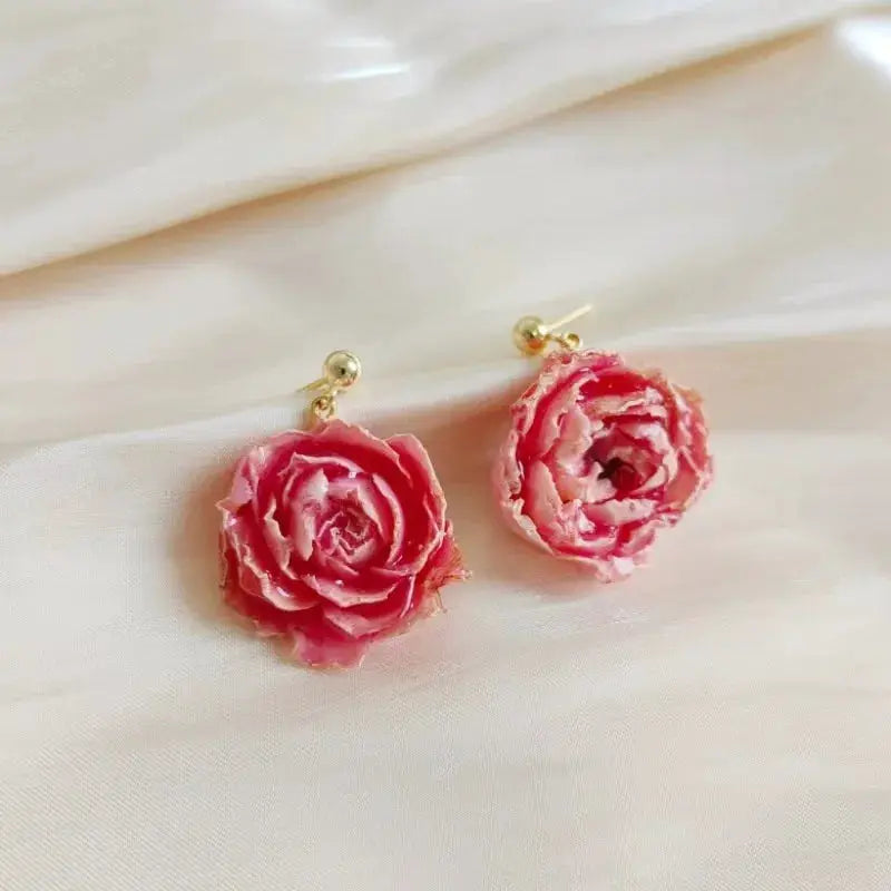 Pink rose epoxy resin earrings with gold stud posts; pair shown