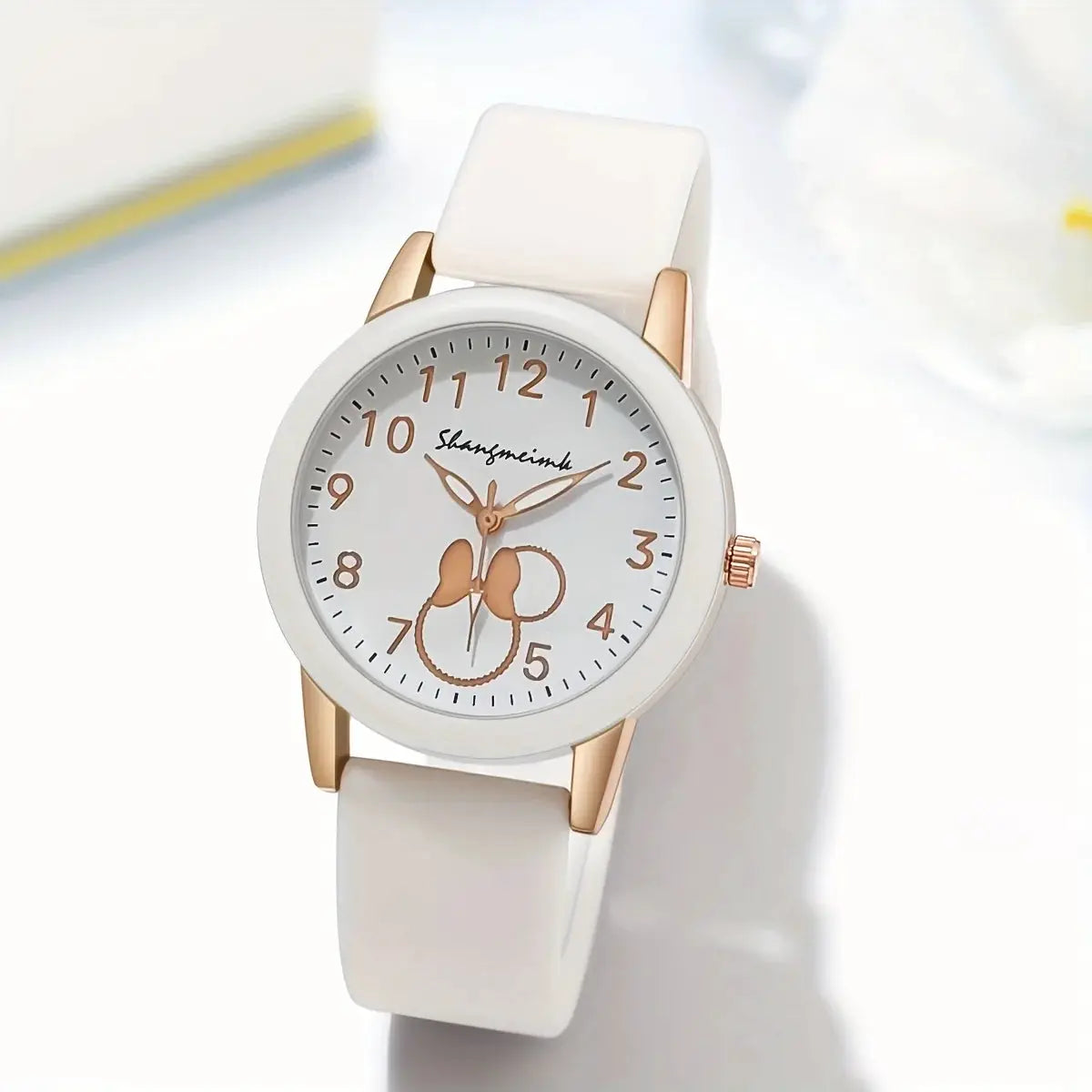 Casual round women's quartz watch with white silicone band and rose-gold case; white dial with rose-gold numerals.