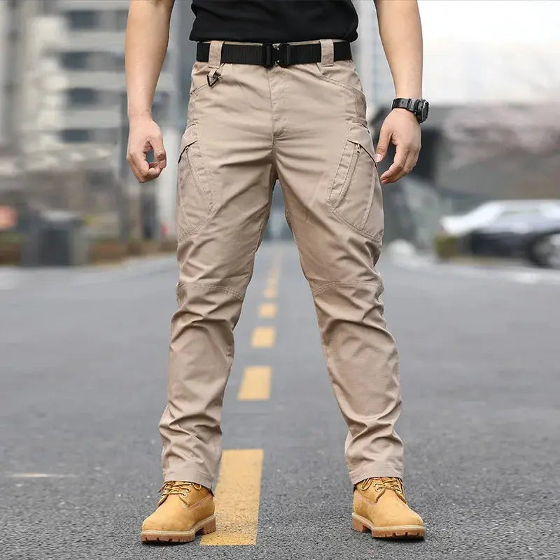 Men's tactical cargo pants in tan with multiple pockets and belt for rugged hiking and work.