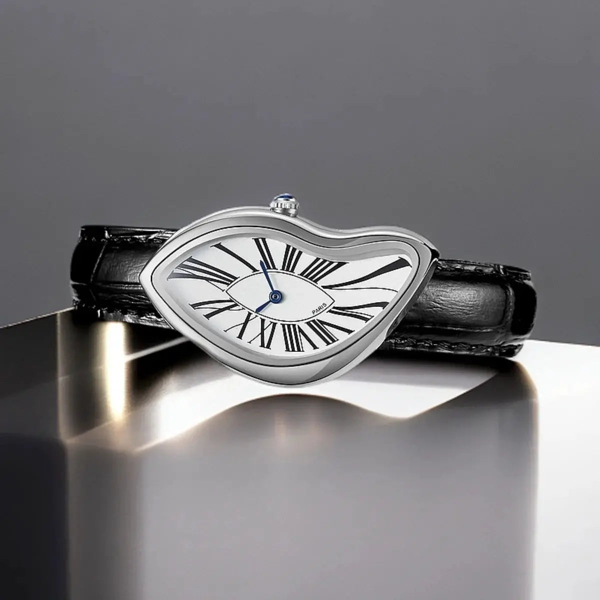 Wristwatch with melted, asymmetrical silver case, white Roman numerals dial, blue hands, black leather strap