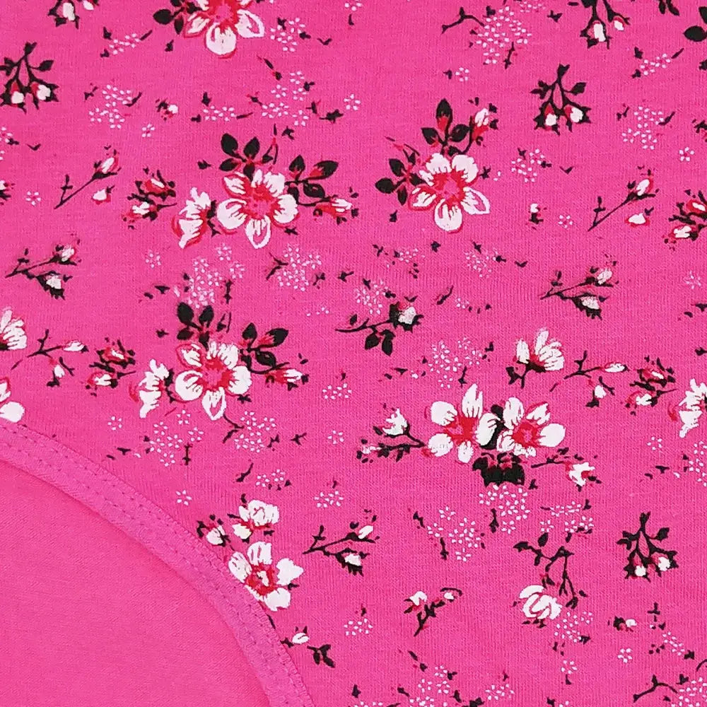 Women's cotton mid-rise briefs in pink with a dense white and black floral print on soft fabric.