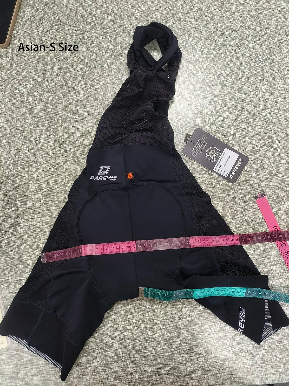 DAREVIE cycling bib shorts, black with mesh panels, brand logo visible and tag attached