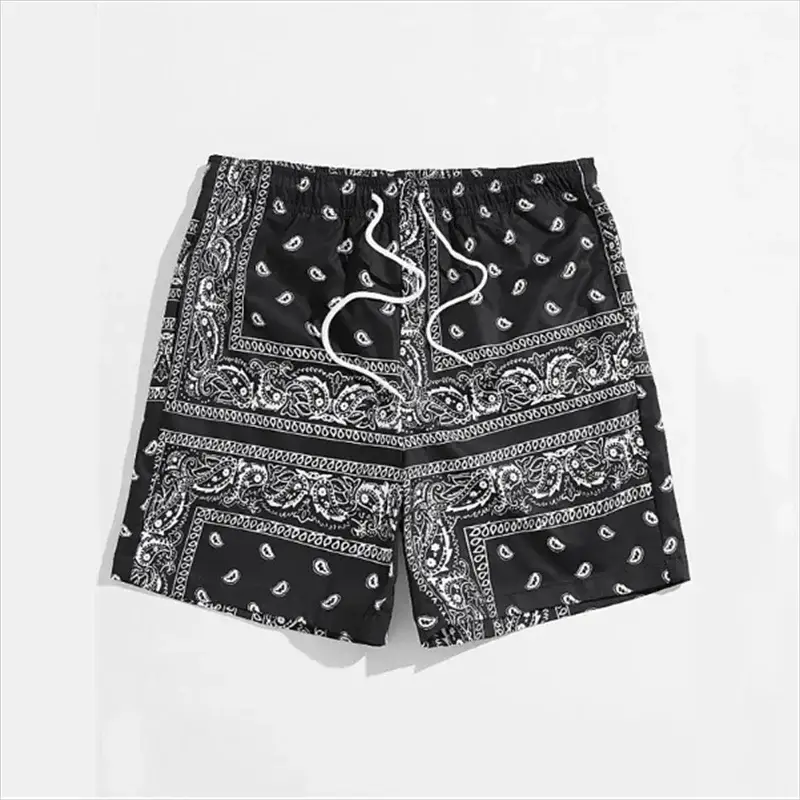 Men's bandana-print swim shorts in black with white paisley pattern and drawstring waist