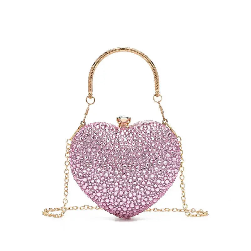Simples Market heart-shaped crystal clutch purse in pink rhinestones with gold-tone handle and chain
