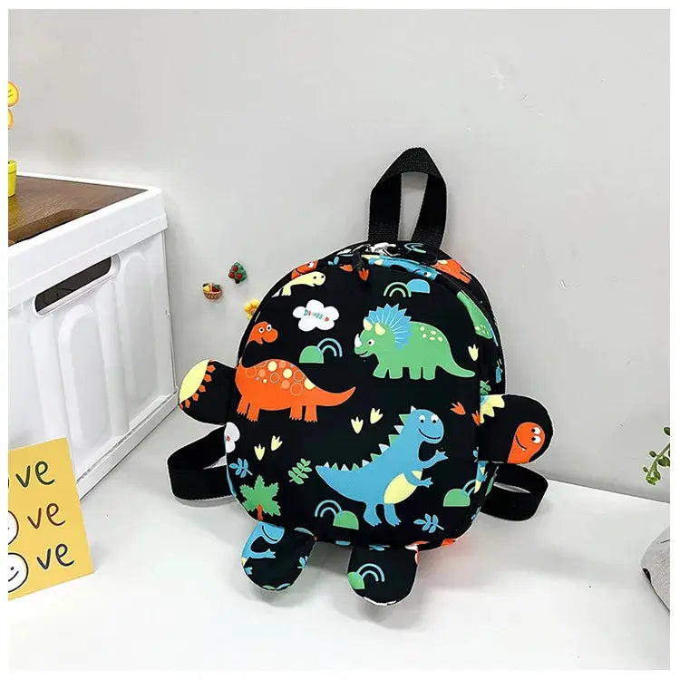 Dinosaur kids backpack by Simples Market, black with colorful cartoon dinosaurs, anti-lost design.