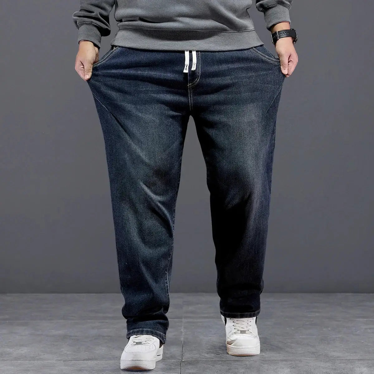 Men's baggy dark blue denim jeans with drawstring waist and loose fit