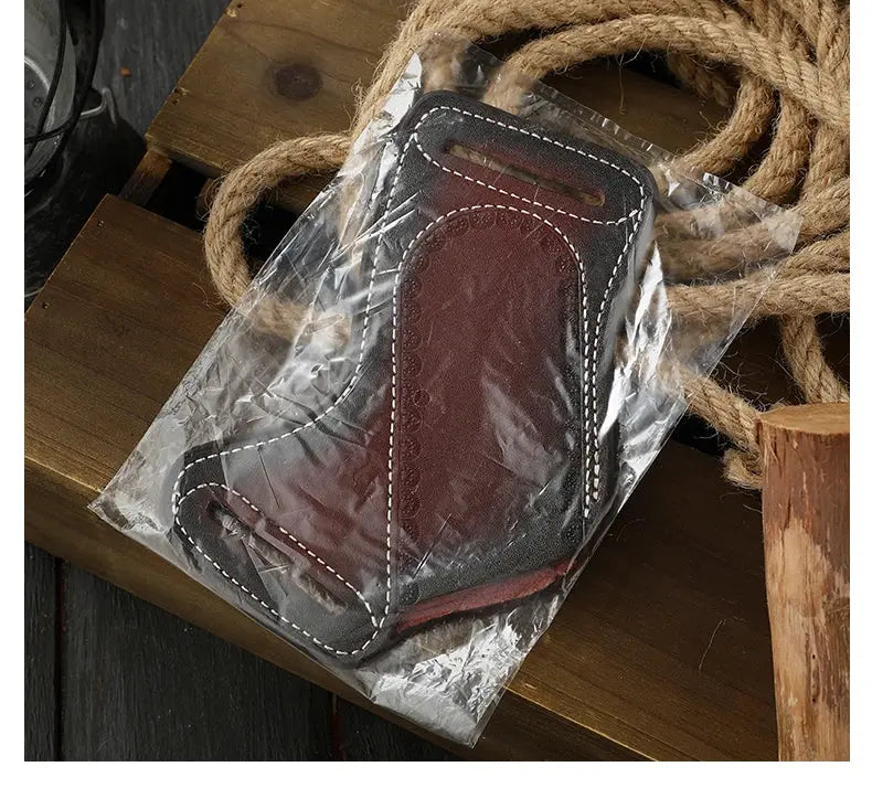 Vintage leather belt knife sheath in brown cowhide with white stitching, in plastic packaging.