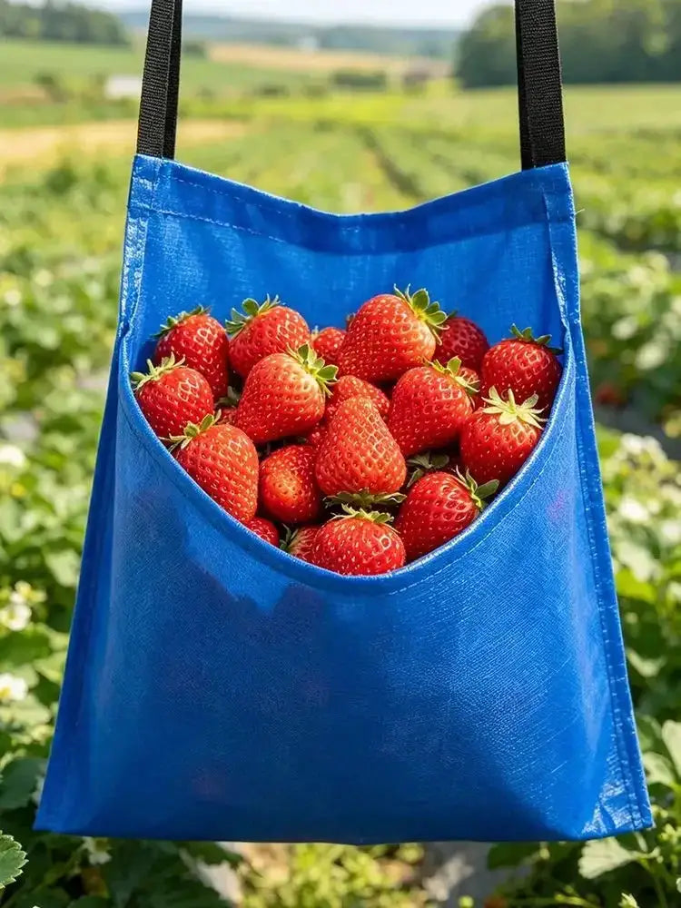 Waterproof fruit-picking apron waist bag in blue by Simples Market filled with strawberries