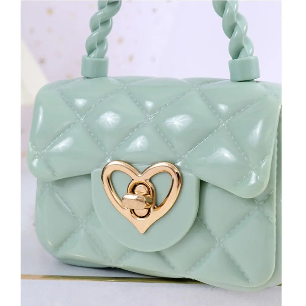 Kids PU leather crossbody bag in mint green, quilted with heart clasp by Simples Market