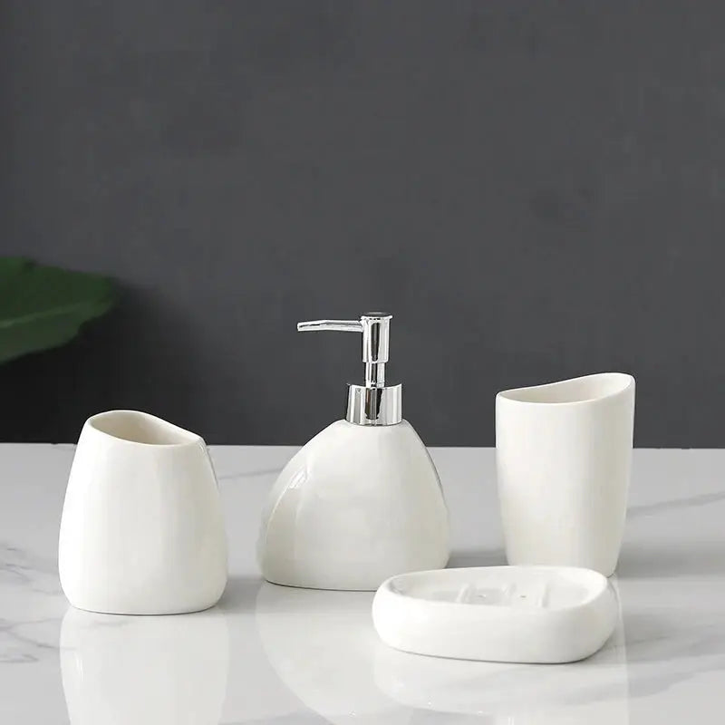 White ceramic bathroom 4-piece set with soap dispenser, mouthwash cup, toothbrush holder, and soap dish.